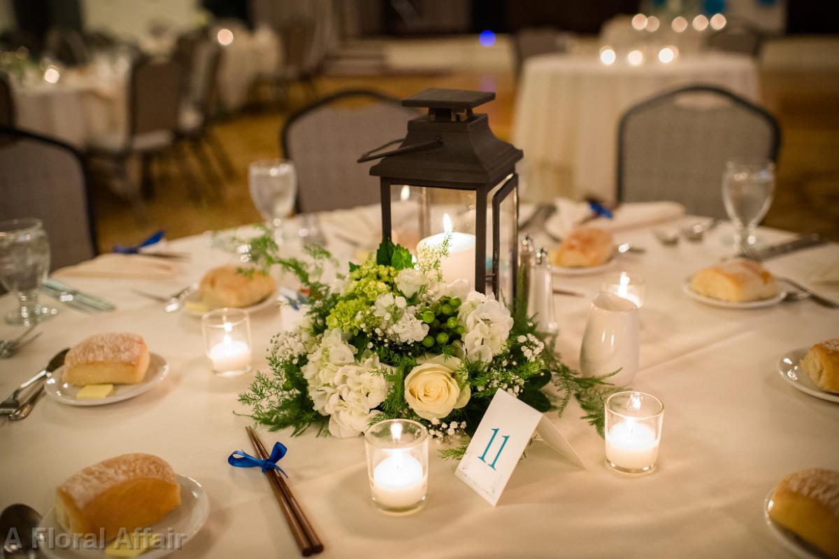 RF1283-Lantern Centerpiece with Greenery, White Hydrangea and Roses